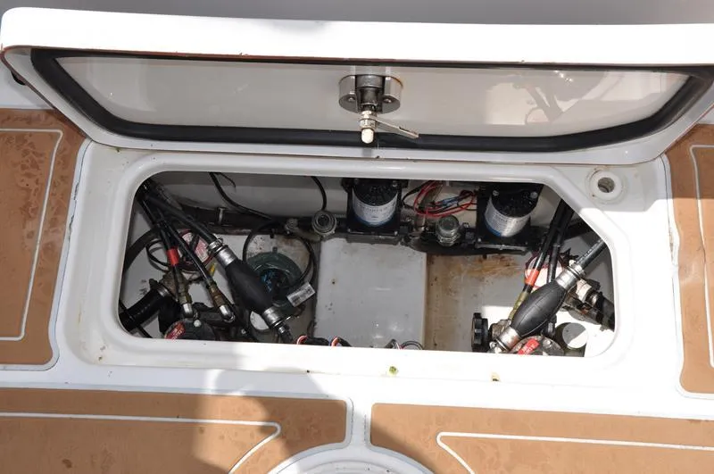 Slide: The Image of 2015 Sea Hunt Gamefish 30 boat compartment with wiring and pumps visible. - 23