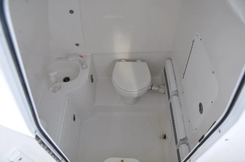 Slide: The Image of 2015 Sea Hunt Gamefish 30 boat bathroom with toilet and sink. - 25