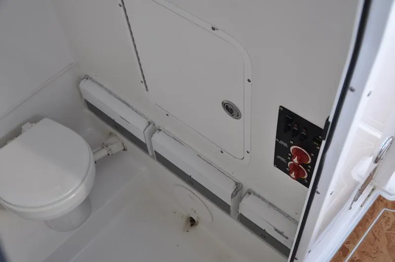 Slide: The Image of 2015 Sea Hunt Gamefish 30 boat interior with toilet and control panel. - 26
