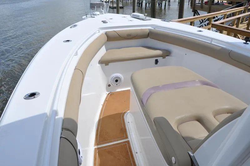Slide: The Image of 2015 Sea Hunt Gamefish 30 boat interior with beige seating and white deck. - 27