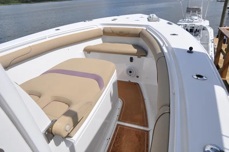 Slide: The Image of 2015 Sea Hunt Gamefish 30 boat interior with cushioned seating and wood flooring. - 28