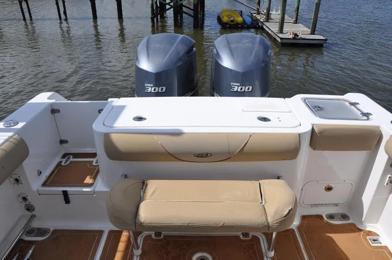 Slide: The Image of 2015 Sea Hunt Gamefish 30 boat with twin Yamaha 300 engines, docked by the water. - 3
