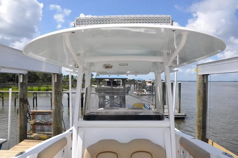 Slide: The Image of 2015 Sea Hunt Gamefish 30 boat docked by a serene waterfront. - 31