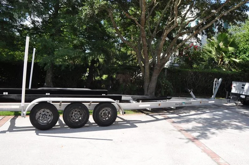 Slide: The Image of Trailer for 2015 Sea Hunt Gamefish 30 boat parked outdoors. - 33