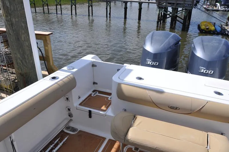 Slide: The Image of 2015 Sea Hunt Gamefish 30 boat with twin Yamaha 300 engines docked by the water. - 4