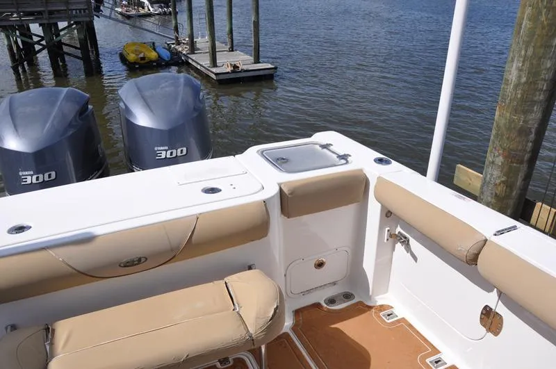 Slide: The Image of 2015 Sea Hunt Gamefish 30 boat with Yamaha 300 engines, docked by the water. - 5