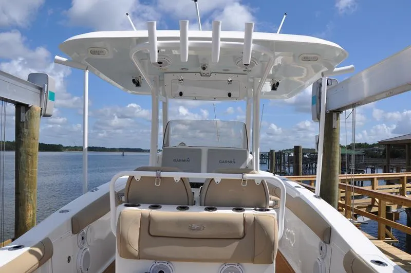 Slide: The Image of 2015 Sea Hunt Gamefish 30 boat docked, featuring spacious seating and modern equipment. - 6