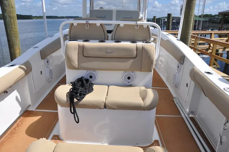 Slide: The Image of 2015 Sea Hunt Gamefish 30 boat interior with beige seating and marine speakers. - 7