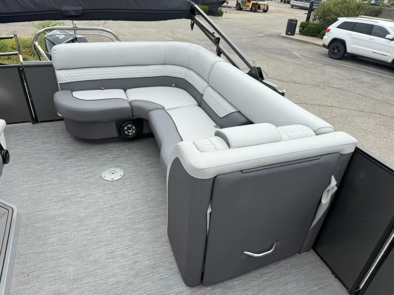 Slide: The Image of Luxurious seating on 2021 Godfrey Monaco 215 C pontoon boat, featuring sleek gray upholstery. - 10