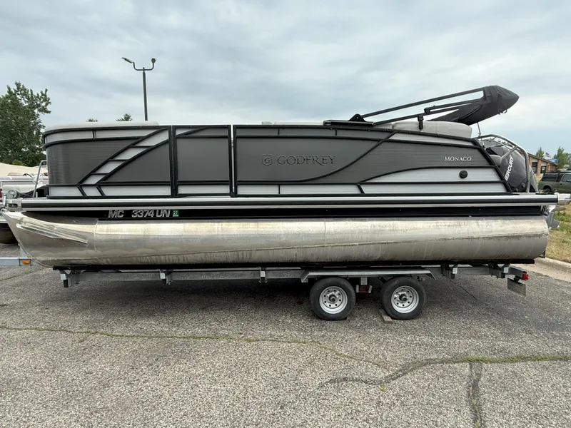 Slide: The Image of 2021 Godfrey Monaco 215 C pontoon boat on trailer, side view. - 2