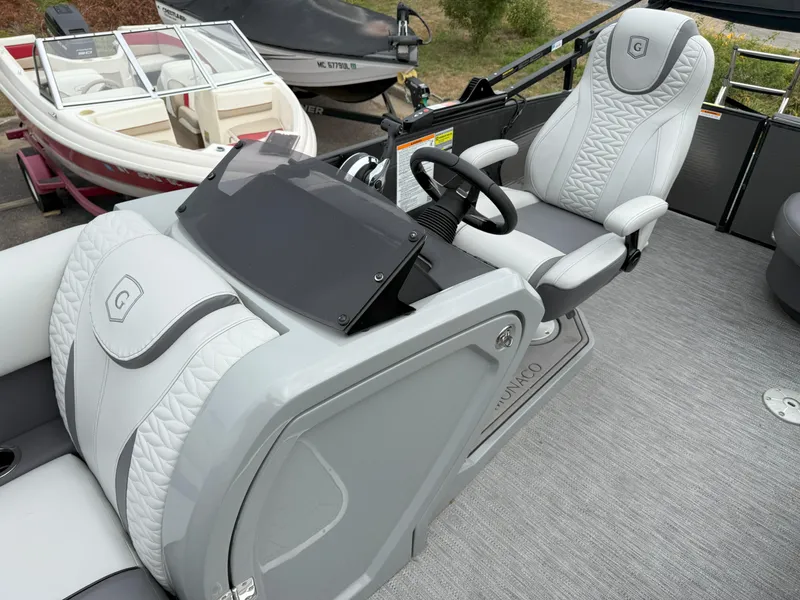 Slide: The Image of 2021 Godfrey Monaco 215 C boat interior with modern helm and luxurious seating. - 9