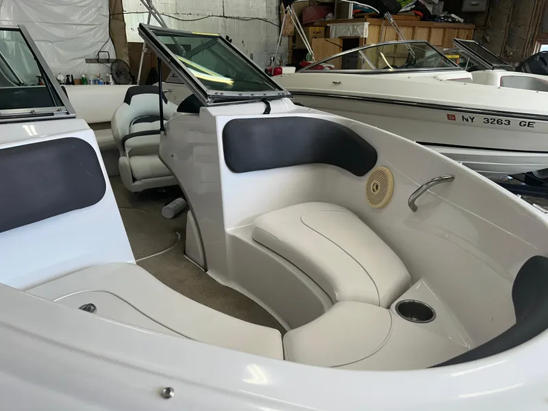 Slide: The Image of Interior of 2011 Four Winns H180 boat with white seating and storage compartments. - 10