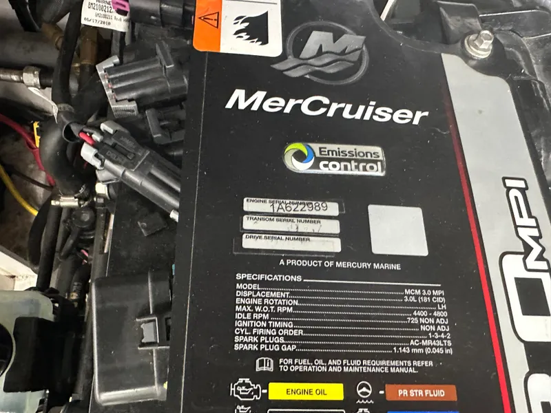 Slide: The Image of MerCruiser engine label on a 2011 Four Winns H180 boat, showing specifications and emissions control. - 2
