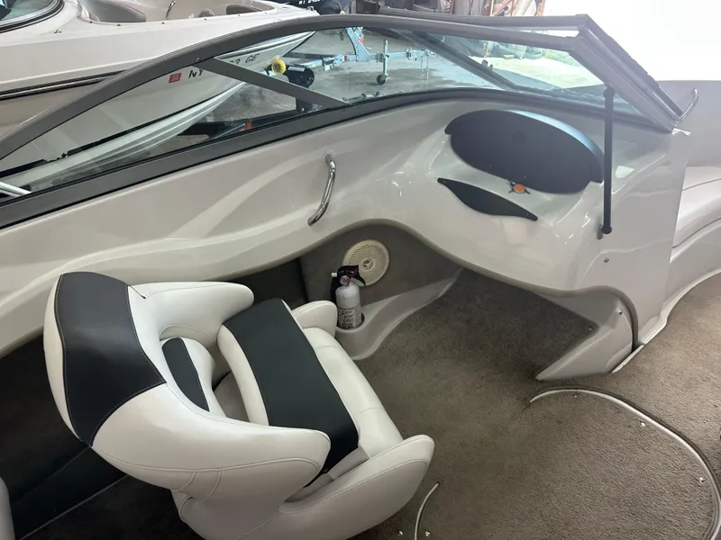 Slide: The Image of Interior of a 2011 Four Winns H180 boat, featuring a sleek design and comfortable seating. - 4