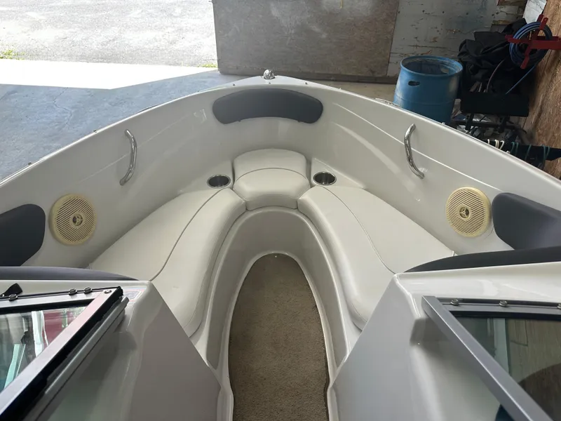 Slide: The Image of Interior of 2011 Four Winns H180 boat with white seating and speakers. - 7