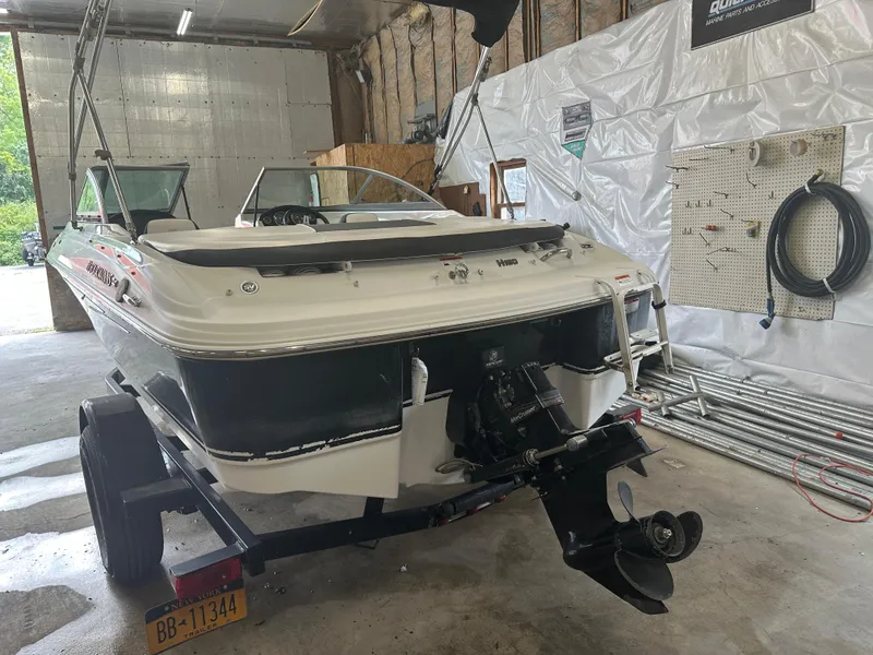 Slide: The Image of 2011 Four Winns H180 boat in garage, rear view, on trailer. - 8