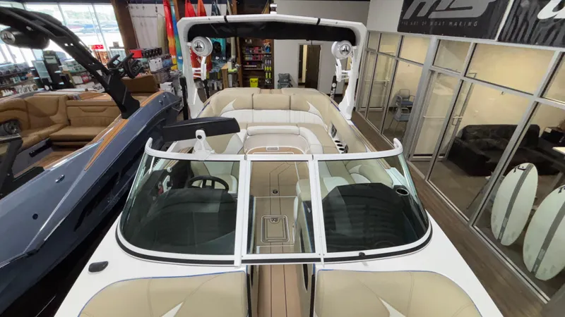 Slide: The Image of 2025 MB B52 23 Classic boat interior in showroom, featuring beige seating and modern design. - 32