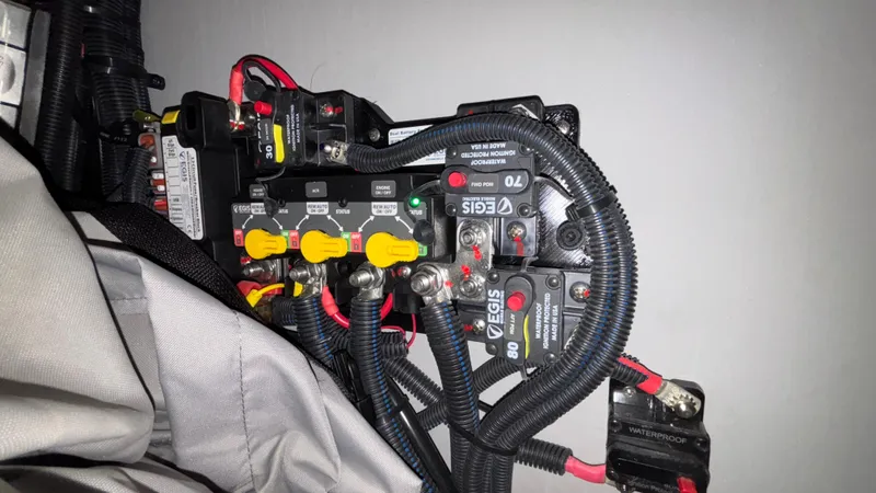 Slide: The Image of Electrical panel with circuit breakers and wiring in MB B52 23 Classic, 2025 model. - 35