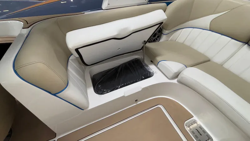 Slide: The Image of 2025 MB B52 23 Classic boat interior with open storage compartment and beige seating. - 42
