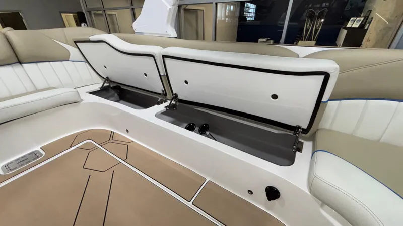 Slide: The Image of 2025 MB B52 23 Classic boat interior with open storage compartments and beige seating. - 43