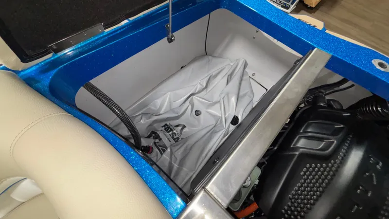 Slide: The Image of 2025 MB B52 23 Classic boat interior storage compartment with engine and wiring visible. - 48