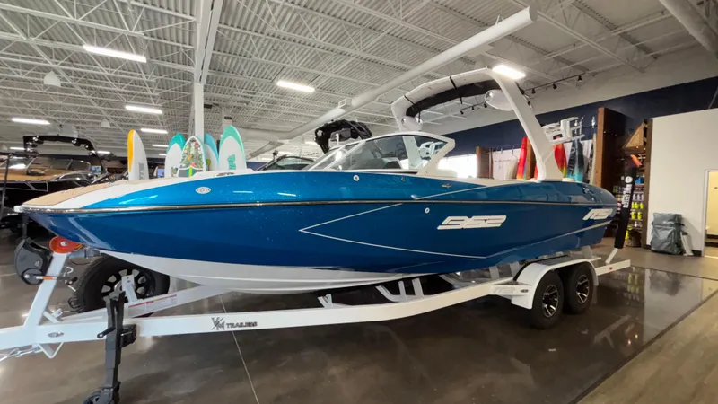 Slide: The Image of 2025 MB B52 23 Classic boat in showroom, blue exterior, on a trailer. - 8