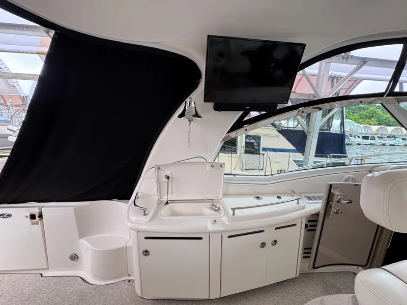 Slide: The Image of Interior of 2003 Sea Ray 500 Sundancer with white seating and table. - 11