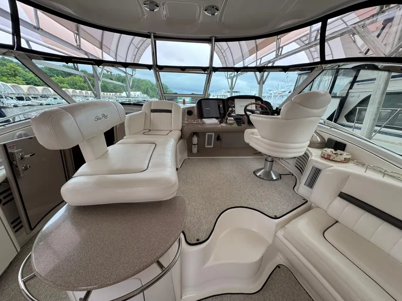 Slide: The Image of Interior of 2003 Sea Ray 500 Sundancer yacht with TV and storage cabinets. - 12
