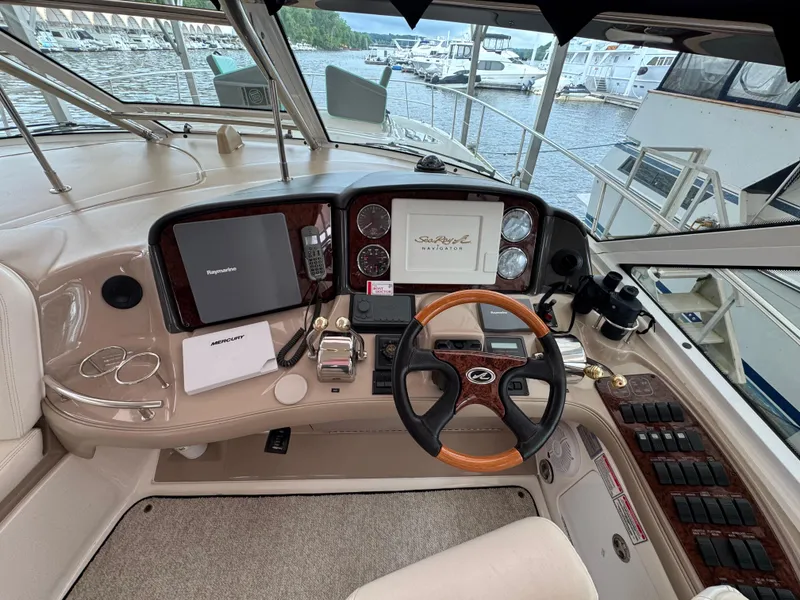 Slide: The Image of Luxurious interior of 2003 Sea Ray 500 Sundancer yacht with plush seating and helm. - 14