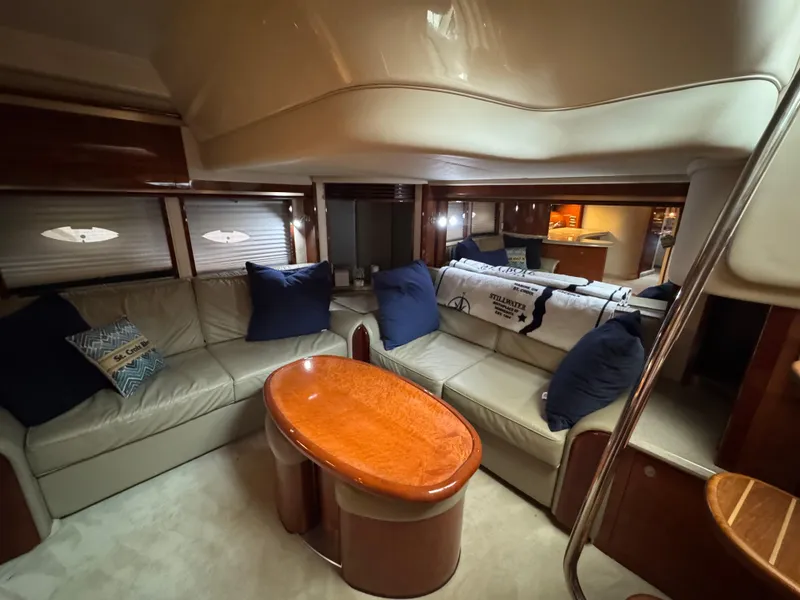 Slide: The Image of Interior view of 2003 Sea Ray 500 Sundancer yacht, featuring seating and cabin entrance. - 18
