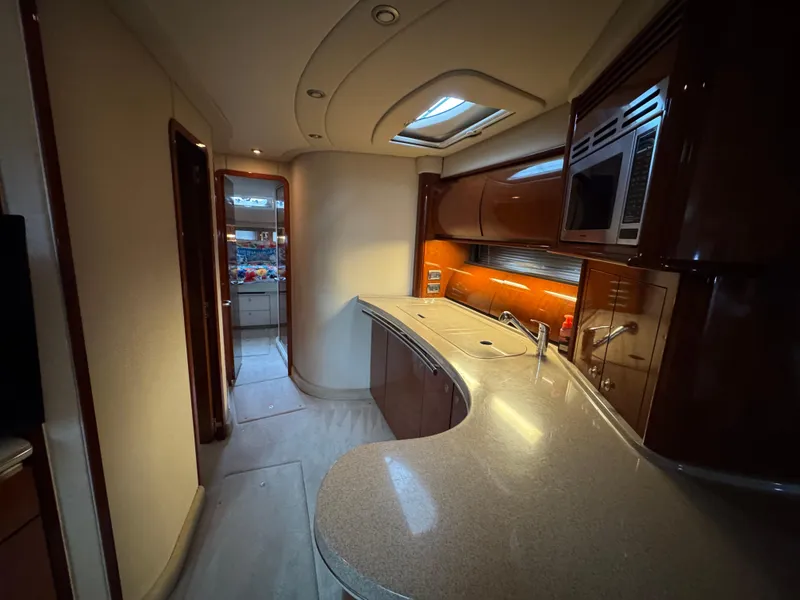 Slide: The Image of Luxurious interior of 2003 Sea Ray 500 Sundancer yacht with plush seating and elegant wood finishes. - 20