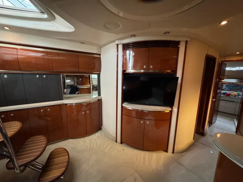 Slide: The Image of Luxurious interior of a 2003 Sea Ray 500 Sundancer yacht, featuring a modern kitchen area. - 22