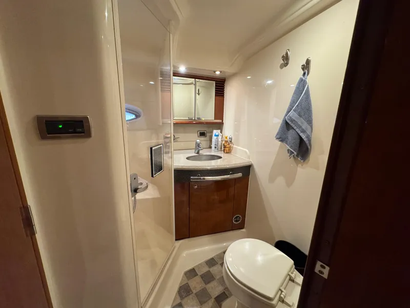 Slide: The Image of 2003 Sea Ray 500 Sundancer cabin interior with wooden cabinetry and bunk beds. - 28