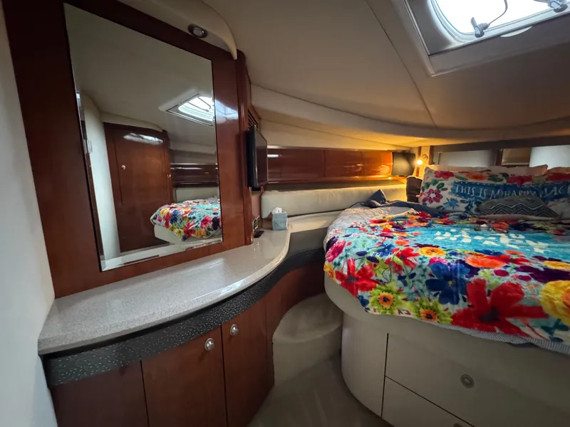 Slide: The Image of Luxurious cabin interior of 2003 Sea Ray 500 Sundancer with floral bedding. - 33