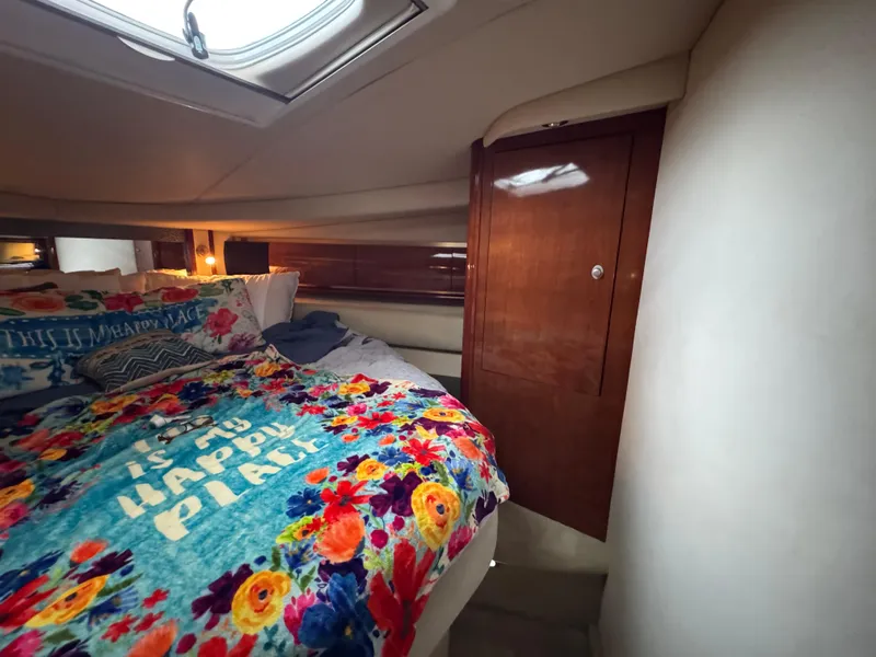 Slide: The Image of Luxurious cabin interior of 2003 Sea Ray 500 Sundancer with colorful bedding. - 34