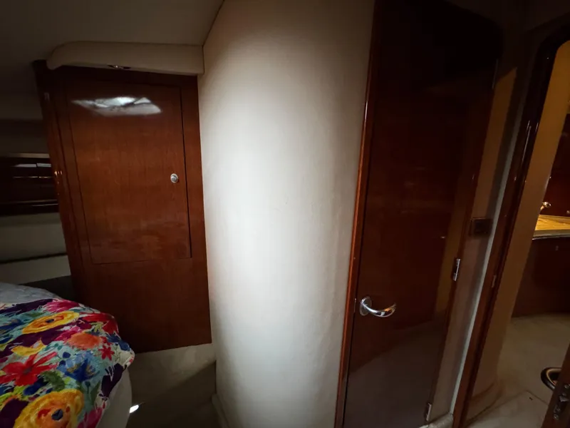 Slide: The Image of Luxurious cabin interior of 2003 Sea Ray 500 Sundancer with floral bedding and wooden cabinetry. - 35