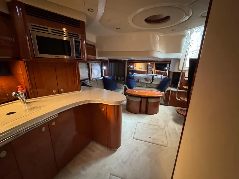 Slide: The Image of Luxurious 2003 Sea Ray 500 Sundancer cabin with TV, mirror, and vibrant floral bedding. - 43