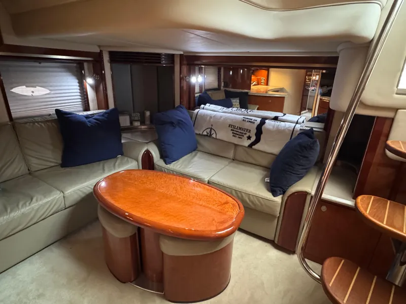 Slide: The Image of Interior of 2003 Sea Ray 500 Sundancer yacht with polished wood and modern amenities. - 44
