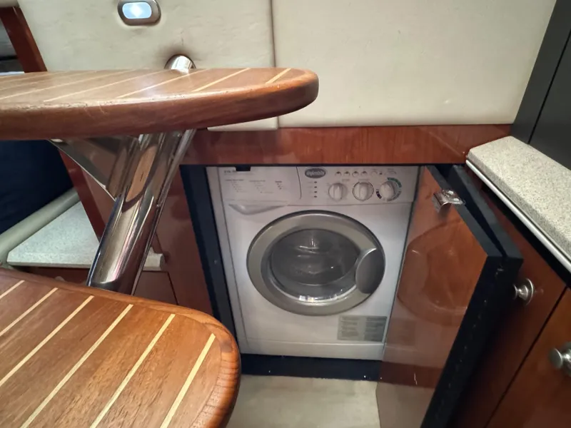 Slide: The Image of Luxurious interior of 2003 Sea Ray 500 Sundancer yacht with modern kitchen and cozy seating area. - 45