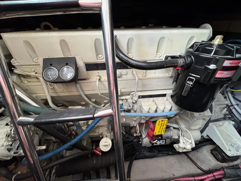 Slide: The Image of 2003 Sea Ray 500 Sundancer interior with open engine hatch, revealing engine compartment. - 48