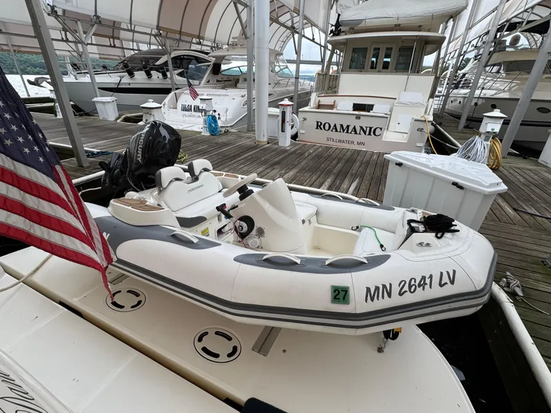 Slide: The Image of 2003 Sea Ray 500 Sundancer yacht docked under a canopy with American flag. - 5