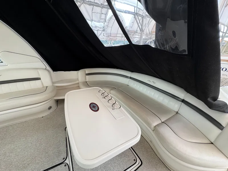 Slide: The Image of 2003 Sea Ray 500 Sundancer yacht interior with seating and table at marina. - 9