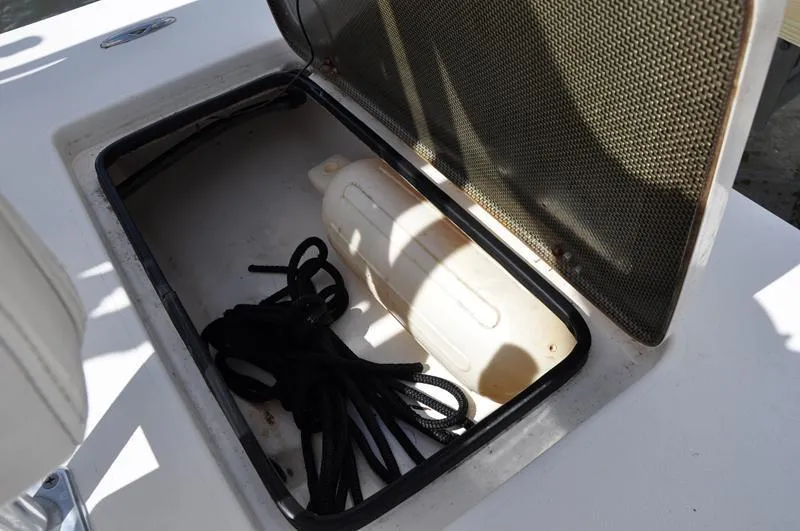 Slide: The Image of Open storage compartment on a 2008 Sterling 180TS boat with rope and fender. - 10