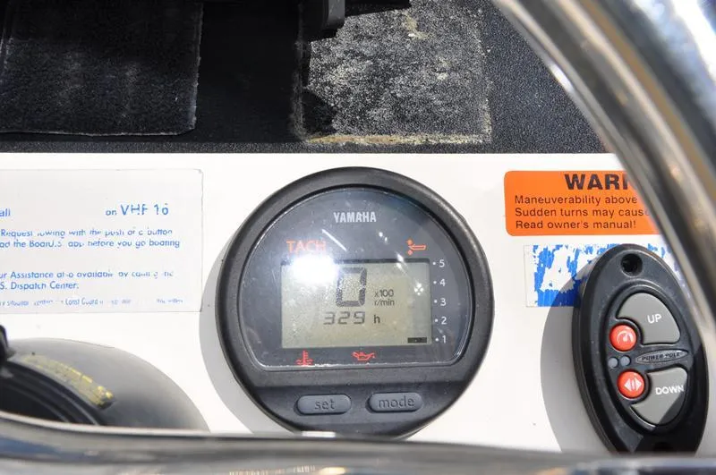 Slide: The Image of Yamaha tachometer on 2008 Sterling 180TS boat dashboard, showing 329 hours. - 11