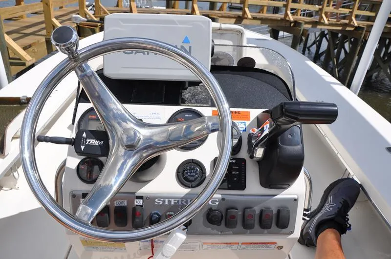 Slide: The Image of 2008 Sterling 180TS boat dashboard with steering wheel and controls. - 12