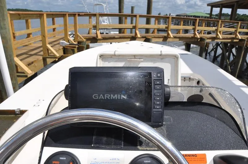 Slide: The Image of Sterling 180TS boat dashboard with Garmin GPS, docked by wooden pier, 2008 model. - 13