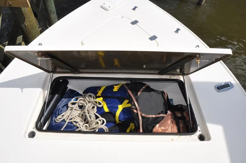 Slide: The Image of Open storage compartment on 2008 Sterling 180TS boat with ropes and gear inside. - 15