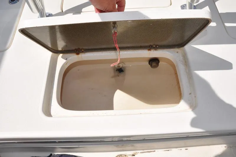 Slide: The Image of Open storage compartment on a 2008 Sterling 180TS boat deck. - 8