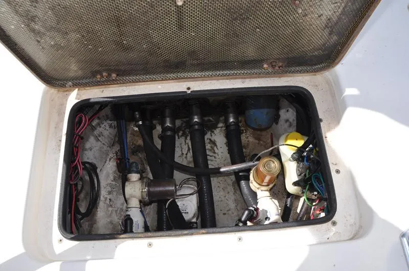 Slide: The Image of Open hatch of a 2008 Sterling 180TS boat showing internal components and wiring. - 9