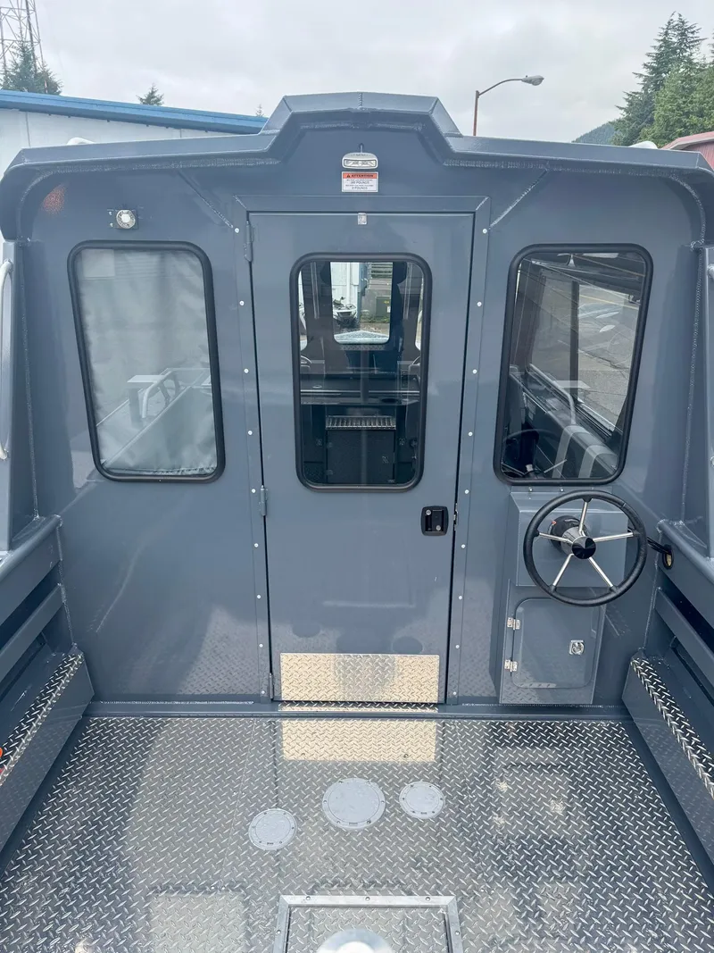 Slide: The Image of 2024 Hewescraft 220 Ocean Pro ET HT boat interior with steering wheel and metal flooring. - 10